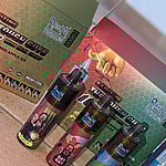 Three R and M Tornado vape devices with colorful character designs are displayed in front of their packaging boxes, which have a hexagonal pattern and product branding.