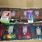 A cardboard box filled with several packaged disposable vape devices labeled "Bang King" with various colorful designs.