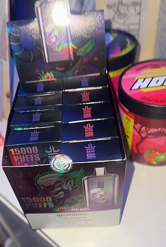 Display of "Bang King" disposable vape devices in a retail box with colorful packaging featuring a cartoonish character.