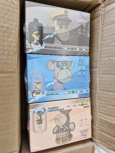 Three boxes of vape products featuring cartoonish monkey characters, each representing a different flavor: Mixed Berries, Grape Ice, and Strawberry Banana.