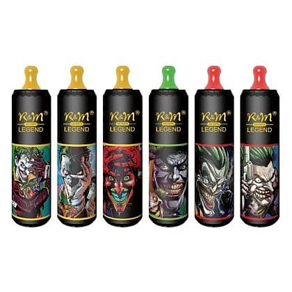 Six cylindrical vape devices with colorful cartoonish Joker-inspired designs and colored mouthpieces in yellow, green, and red.