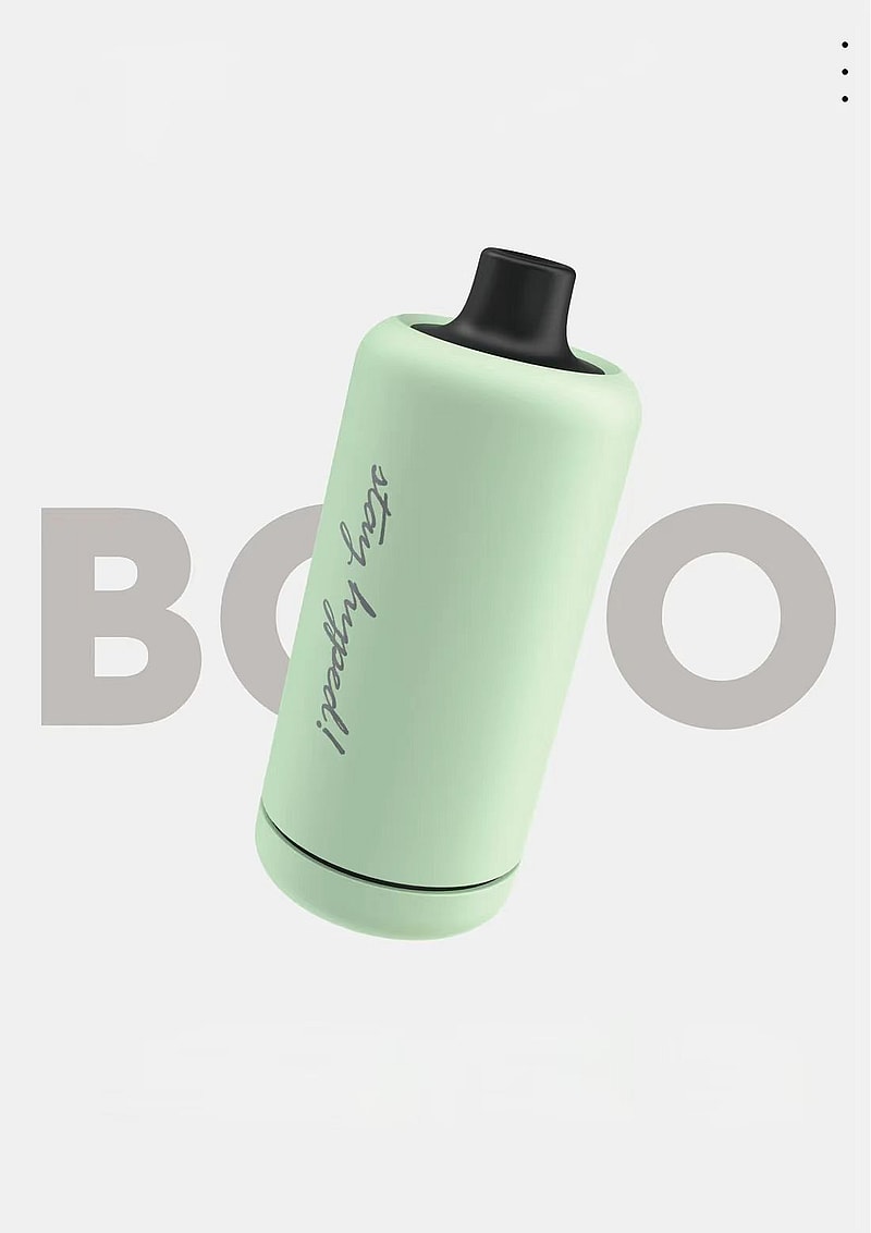 Un appareil cylindrique vert menthe avec un embout noir, comportant le texte « stay hyped! » écrit en cursive.