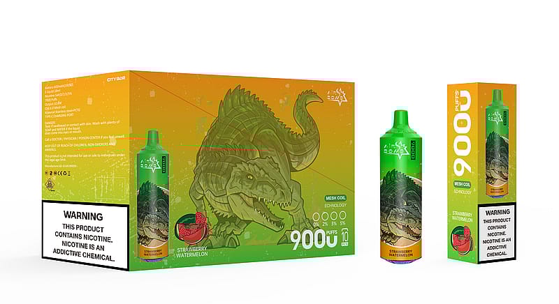 Une boîte et un appareil à vapotage représentant un crocodile vert, étiquetés « 9000 bouffées » et saveur « Fraise Pastèque », avec une étiquette d'avertissement de nicotine en bas.