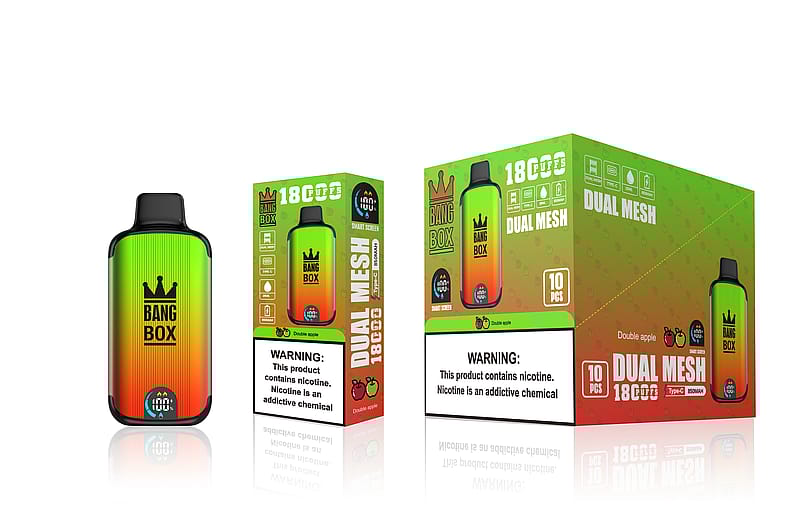 Un dispositif de vaporisation dégradé vert et orange étiqueté "Bang Box" à côté de boîtes d'emballage assorties portant les mentions "18 Cups", "Dual Mesh" et des étiquettes d'avertissement sur la nicotine.
