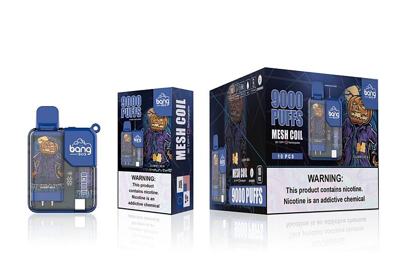 Bang Box vape device and packaging displaying "9000 puffs" and "Mesh Coil" with a Halloween-themed design featuring a pumpkin-headed figure. The warning label states, "This product contains nicotine. Nicotine is an addictive chemical."