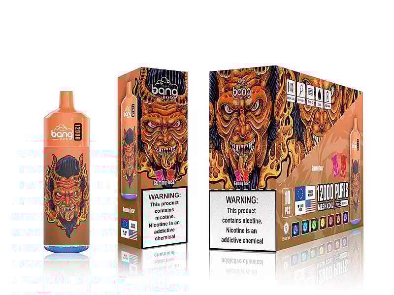 Una caja y un dispositivo de vapeo desechables con un diseño estilizado de cara de demonio ardiente y la marca "Bang Box". El envase incluye advertencias sobre la adicción a la nicotina y detalles como "12000 PUFFS" y sabor "Gummy bear".