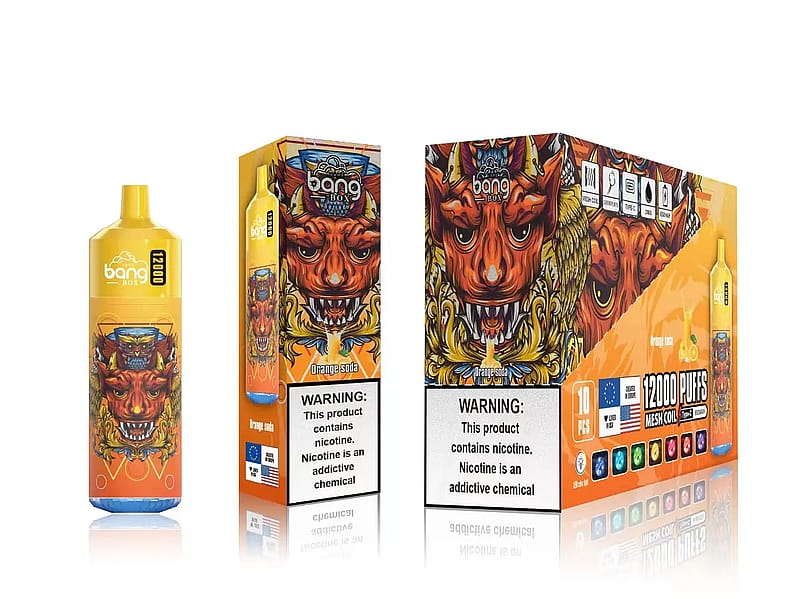 Vapeador desechable Bang Box en envase naranja y amarillo con un feroz gráfico rojo de cara de demonio, etiquetado "Refresco de naranja" y "12.000 caladas". La advertencia sobre la adicción a la nicotina aparece en un lugar destacado.