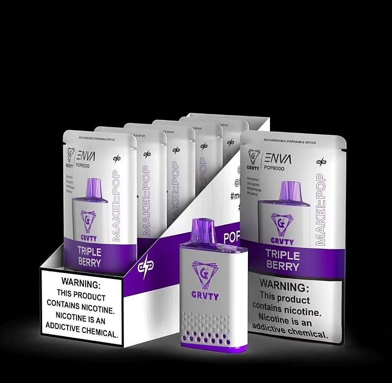 A display of GRVTY brand disposable vape devices in "Triple Berry" flavor, with a warning label stating "This product contains nicotine. Nicotine is an addictive chemical."