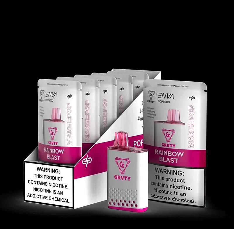 A display of ENVI GRVTY POP8000 rechargeable disposable vaping devices in "Rainbow Blast" flavor, featuring a warning label about nicotine addiction.