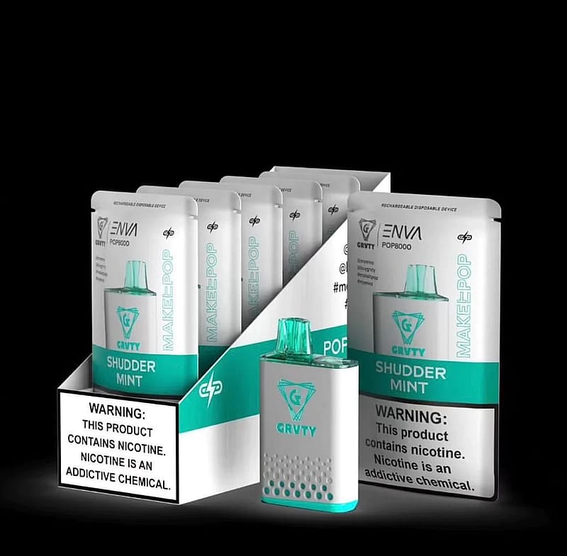 Packaging display of ENVI POP8000 rechargeable disposable vape devices in "Shudder Mint" flavor, featuring multiple sealed packages and one device with a turquoise cap, accompanied by a nicotine warning label.