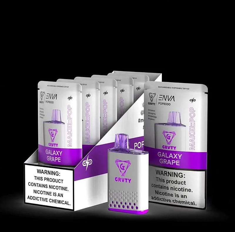 A display setup featuring several GRVTY ENVI POP8000 Galaxy Grape rechargeable disposable vape devices, with packaging emphasizing the product name and warning labels about nicotine addiction.