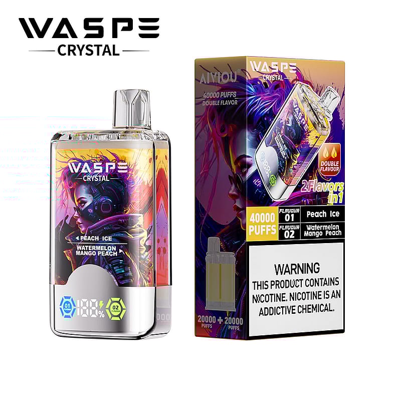 Un appareil à vapotage et son emballage affichant la marque WASPE Crystal. L'emballage annonce deux saveurs : Pêche glacée et Pastèque mangue pêche, avec un total de 40 000 bouffées. Une étiquette d'avertissement bien visible sur la teneur en nicotine se trouve au bas de la boîte.