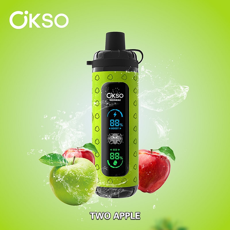A green OKSO Shishai vaping device featuring an apple design and digital display, surrounded by splashes of water and two apples—a red and a green one—against a vibrant green background.