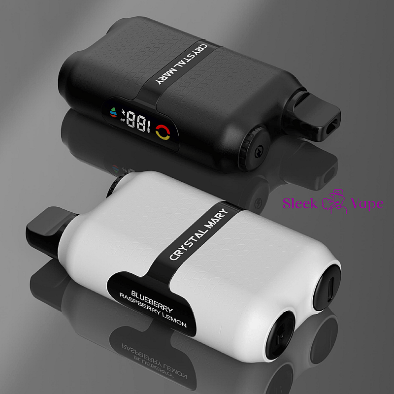 Two modern vape devices, one black and one white, both branded as 'Crystal Mary' lying on a reflective surface; the white device displays 'Blueberry Raspberry Lemon' flavor.
