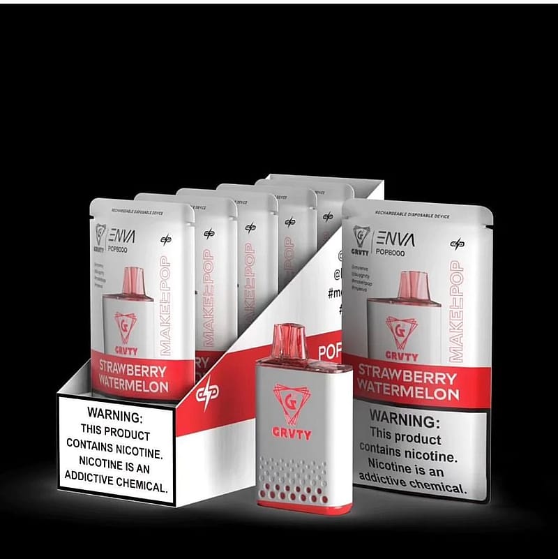A display of strawberry watermelon-flavored disposable vape devices in individual packaging, with one device shown outside the packaging. The packaging and device are white with red accents, and a nicotine warning label is visible.