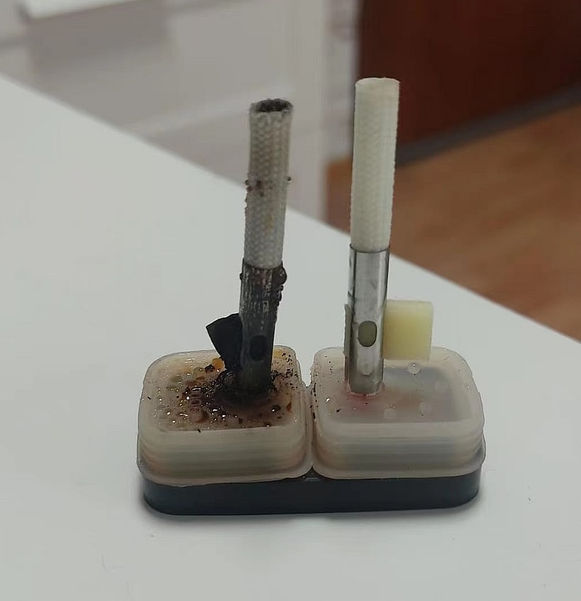 Situación de ardor del cigarrillo electrónico de doble sabor - SleekVape Dos elementos calefactores eléctricos, uno dañado y quemado, el otro intacto, montados sobre una pequeña base.