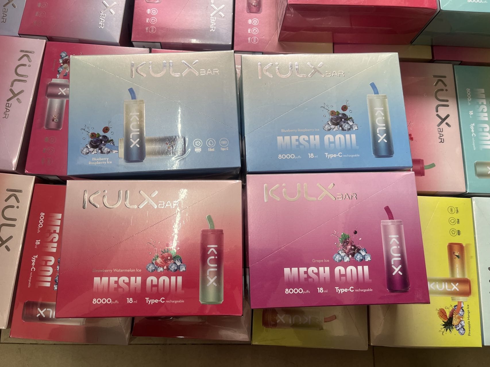 KULX Bar disposable vape boxes in various flavors, including Blueberry Raspberry Ice, Strawberry Watermelon Ice, and Grape Ice, with 8000 puffs, 18mL capacity, mesh coil, and Type-C rechargeable battery.