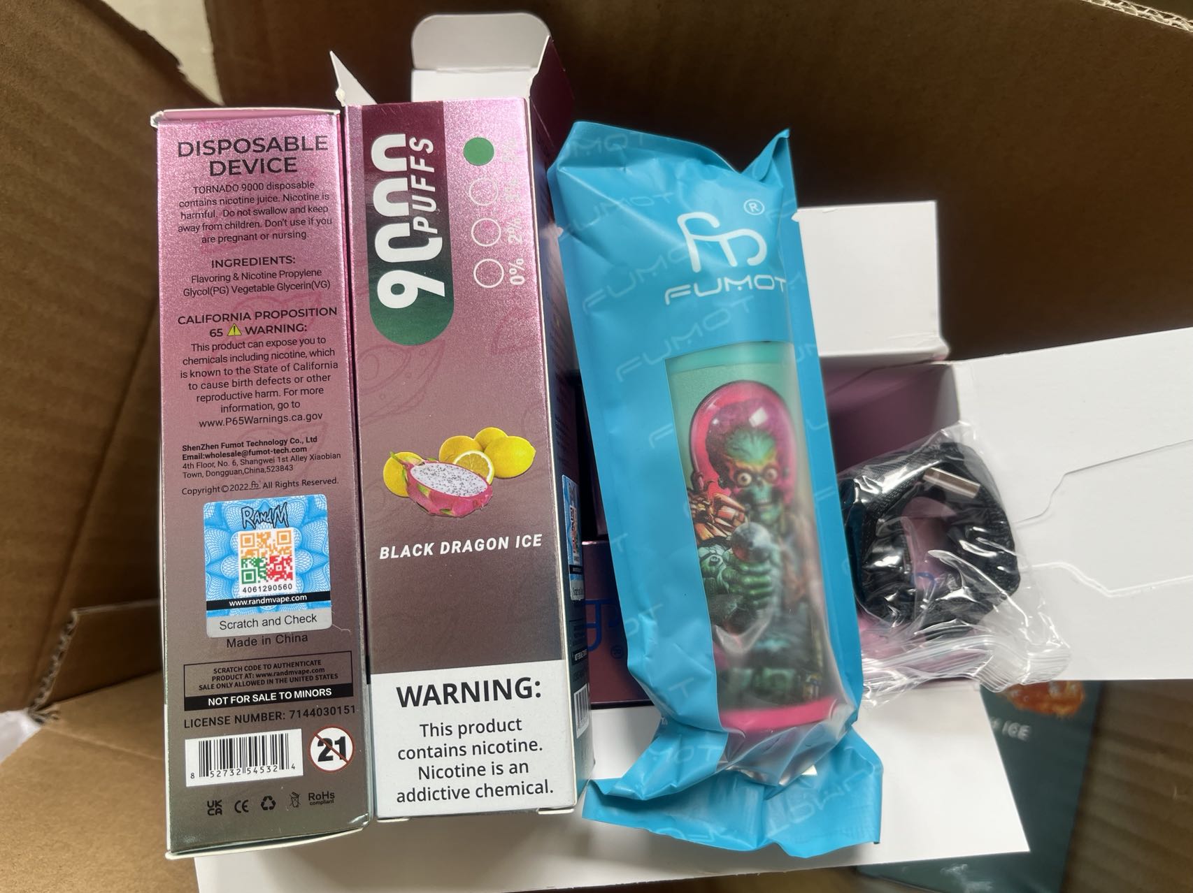 Disposable vape packaging showing a "9000 puffs" device labeled "Black Dragon Ice," with warnings about nicotine addiction and California Proposition 65, alongside a colorful vape wrapped in blue packaging.