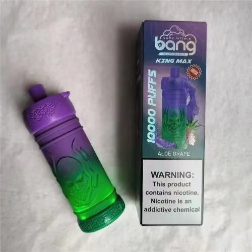 A disposable vape device with a gradient purple to green design, labeled "Bang King Max" with "10,000 Puffs" and "Aloe Grape" flavor, next to its packaging that includes a nicotine warning.