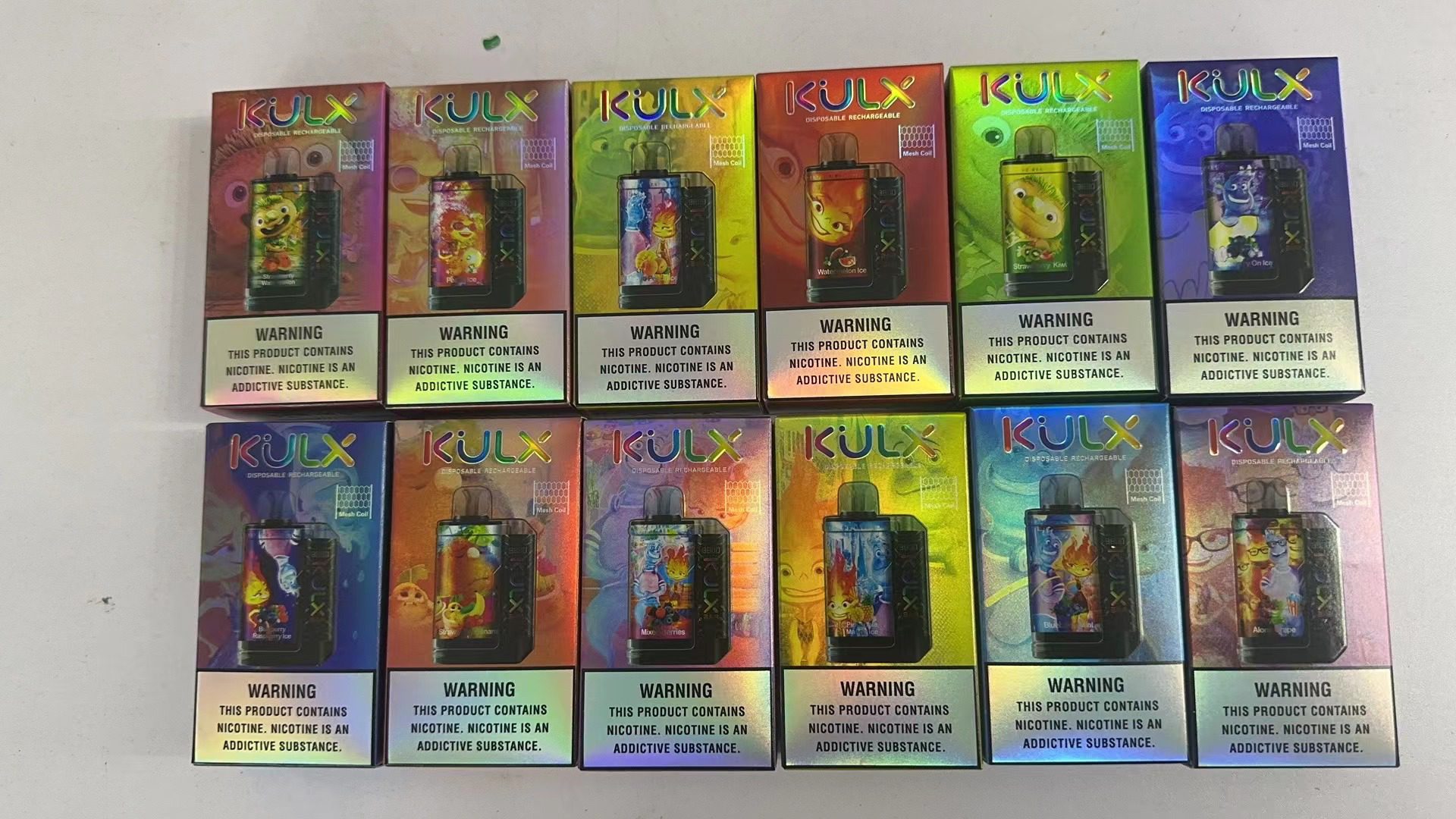 Boxes of KULX disposable rechargeable vaping devices with colorful packaging and nicotine addiction warnings at the bottom.