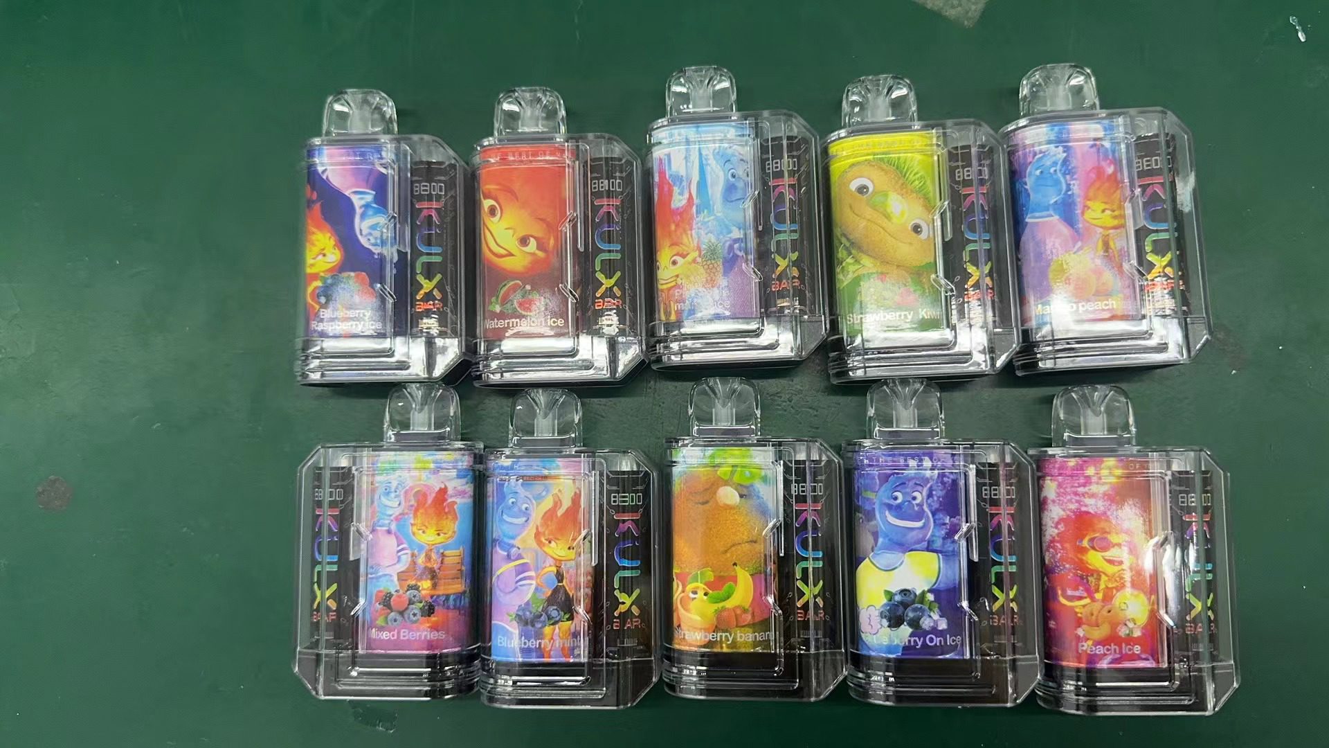 A set of ten colorful disposable vape devices with animated characters on the packaging, each labeled with different fruit flavors such as "Watermelon Ice," "Mango Peach," and "Strawberry Kiwi."