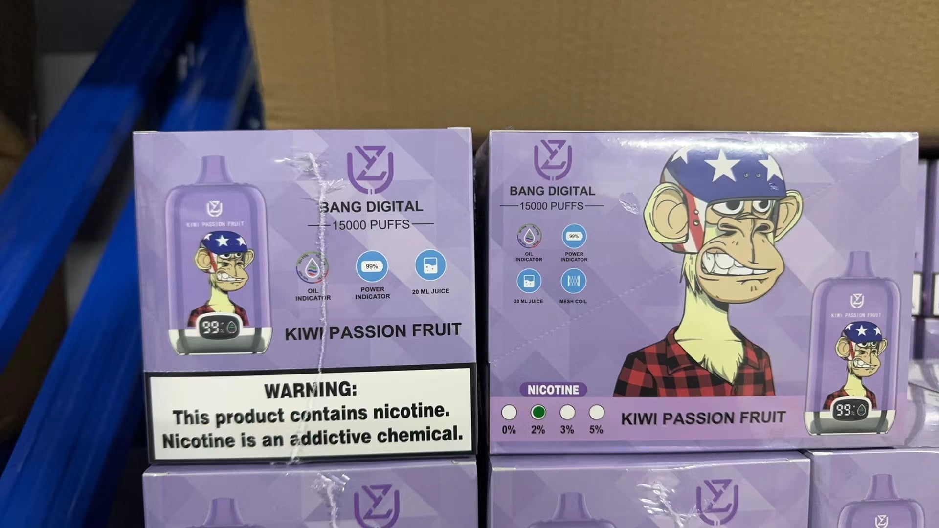 Boxes of "Bang Digital" Kiwi Passion Fruit vape products, featuring an illustrated monkey character wearing a star-spangled helmet and red flannel shirt, with warnings about nicotine content.