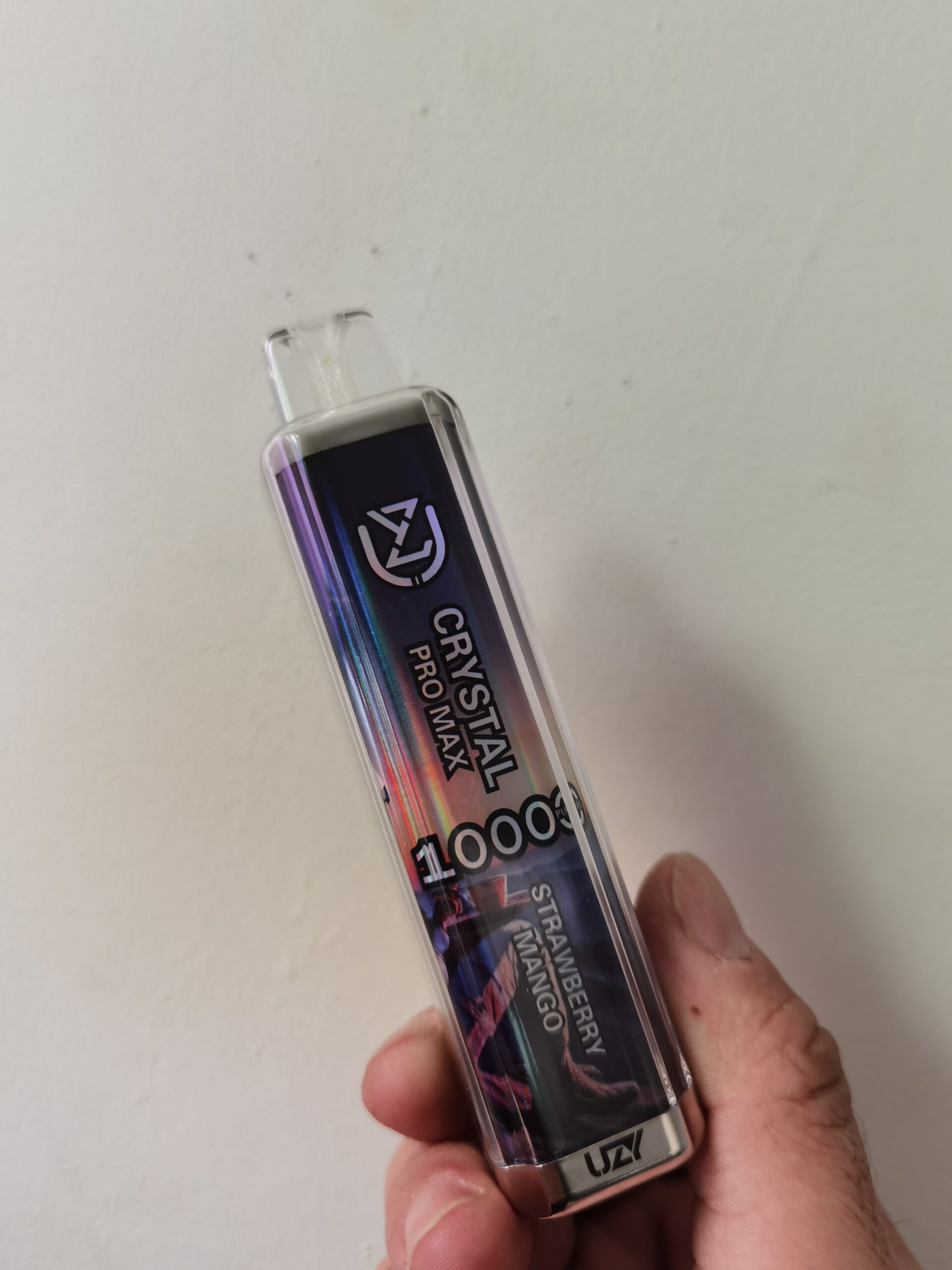 Disposable vape device labeled "Crystal Pro Max 10000" with a strawberry mango flavor.