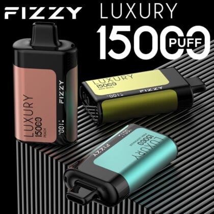 Three luxury vape devices labeled "FIZZY" on a striped surface, each with 15000 puff capacity and different flavor labels: Peach, Red Bull, and Pineapple Mango Ice.