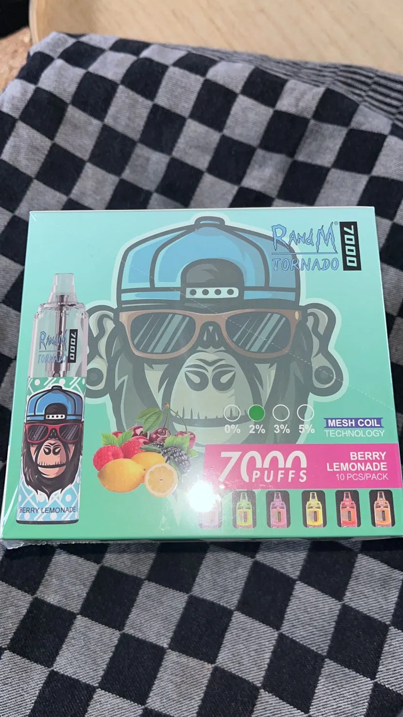 A box of RandM Tornado 7000 puffs disposable vape in Berry Lemonade flavor with an image of a gorilla wearing sunglasses and a cap.